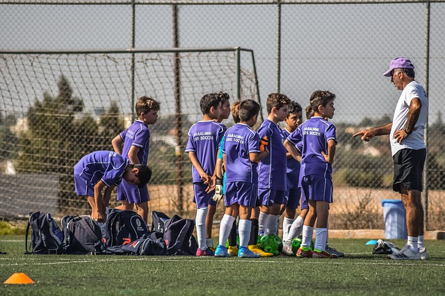 A rugby coach helping out some youngsters